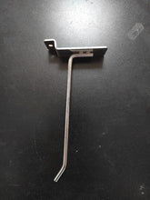 Charger l'image dans la galerie, Tige métallique de rangement en forme de L pour panneau perforé, posée sur un fond sombre.
